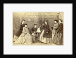 Group portrait of six young women in garden round table with sculpture, hats and coats by L. de Koningh