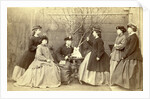 Group portrait of six young women in garden round table with sculpture, hats and coats by L. de Koningh
