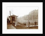 Men, presumably workers, and two cats at a jetty and a guardhouse along a canal by Anonymous