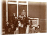 Group of children posing on stairs for entrance doors by Anonymous
