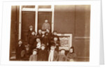 Group of children posing on stairs for entrance doors by Anonymous