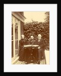 Two men and a woman sitting at home with a book on the table by Anonymous