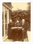 Two men and a woman sitting at home with a book on the table by Anonymous