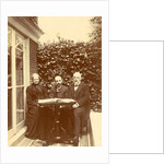 Two men and a woman sitting at home with a book on the table by Anonymous