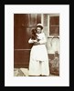 Maid with a dachshund in her arms at an outside tap by Anonymous