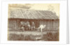 Dutch soldiers sitting in front of a wooden house in the Dutch East Indies by Anonymous