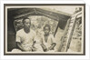 Two Indian boys sitting in roofed wooden boat by Anonymous