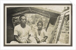 Two Indian boys sitting in roofed wooden boat by Anonymous