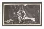 Man and a woman in swimwear on a bench in a forest by Anonymous