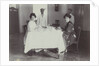 Group portrait of young women at the table with servants in the Dutch East Indies, indonesia by Anonymous