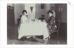 Group portrait of young women at the table with servants in the Dutch East Indies, indonesia by Anonymous
