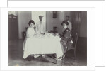 Group portrait of young women at the table with servants in the Dutch East Indies, indonesia by Anonymous