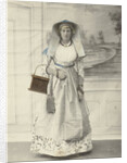 Portrait of a woman in Zaanse costume posing for a background cloth by S. Bakker Jz.