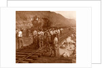 Spanish laborers at work in Culebra Cut and loaded train hauling dirt from canal, USA by Anonymous
