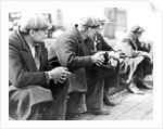 Row of men at the New York City docks out of work during the depression, 1934 by Lewis Hine