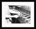 Paterson, New Jersey - Textiles. Quiller tying the broken ends of thread being wound on to quills, March 1937 by Lewis Hine