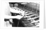 Paterson, New Jersey - Textiles. Quiller tying the broken ends of thread being wound on to quills, March 1937 by Lewis Hine