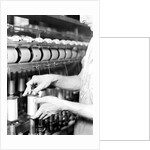 Paterson, New Jersey - Textiles. Rayon yarn being wound from one bobbin on to another and being twisted, March 1937 by Lewis Hine