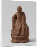 Man figure with raised right leg on rocky pedestal. Red stoneware. by Anonymous