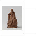 Man figure with raised right leg on rocky pedestal. Red stoneware. by Anonymous