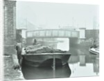 Man mooring a barge by a river bank, Poplar, London, 1905 by Unknown