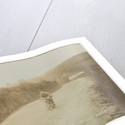 Rider passing along Kirk Michael to Peel coast road, captioned ‘C.R.Collier, winner of the motorcycle race’, likely to be 1907 TT (Tourist Trophy) by Anonymous