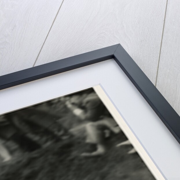 Bob McIntyre, TT (Tourist Trophy) rider, riding 499cc Norton (number 1) over the Mountain by T.M. Badger