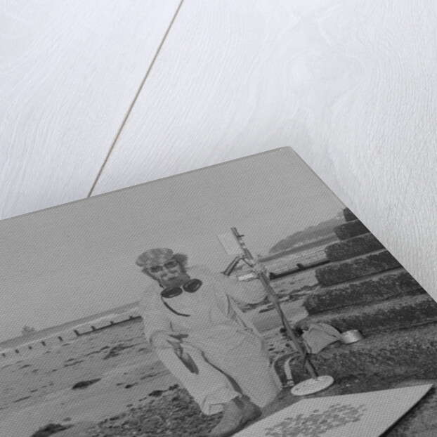 Metal detectorist on Douglas beach by Manx Press Pictures