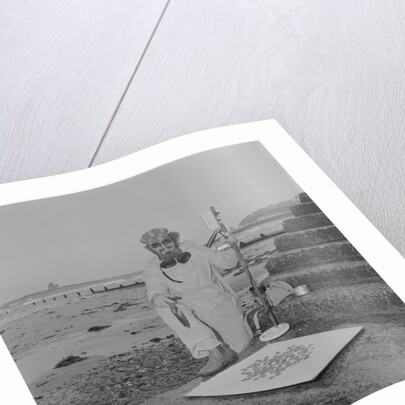 Metal detectorist on Douglas beach by Manx Press Pictures