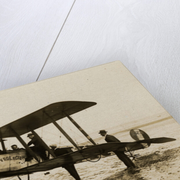 Plane No. 9 on the shore at Ramsey belonging to A.V. Roe and Co. Ltd. G.W. Kewin, town surveyor climbing into the cockpit by Thomas Horsfell Midwood