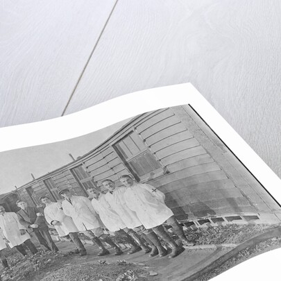 First World War Internee in front of hut with medical/hospital staff, Camp 2, Knockaloe by W H Warburton