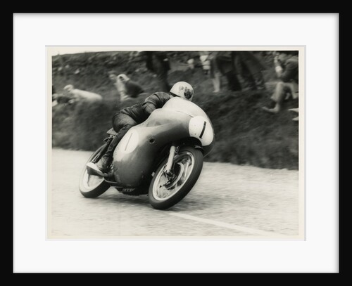 Bob McIntyre, TT (Tourist Trophy) rider, riding 499cc Norton (number 1) over the Mountain by T.M. Badger