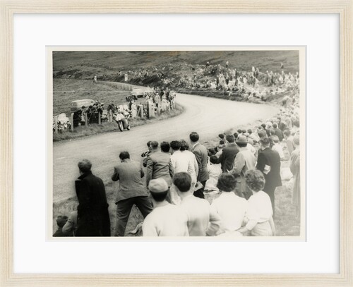 TT (Tourist Trophy) rider number 1 passes large crowd on the Mountain by T.M. Badger