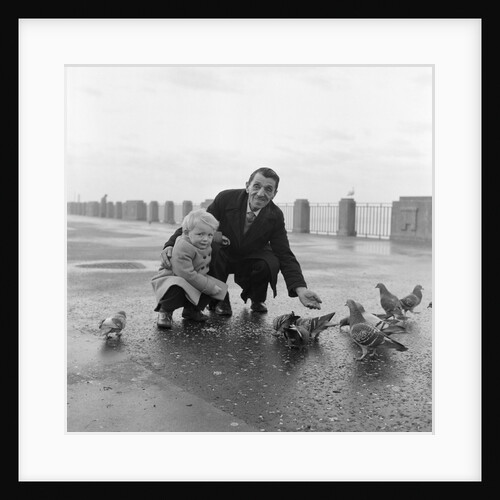 Feeding pigeons on Douglas Promenade by Manx Press Pictures