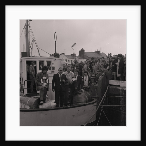 Radio Caroline disc jockeys Dave Lee Travis (on left with life ring) and Tony Prince (right with badges on jacket) on boat, Ramsey harbourside by Manx Press Pictures