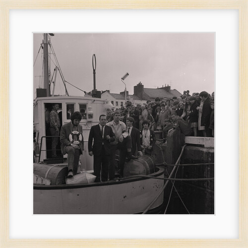 Radio Caroline disc jockeys Dave Lee Travis (on left with life ring) and Tony Prince (right with badges on jacket) on boat, Ramsey harbourside by Manx Press Pictures