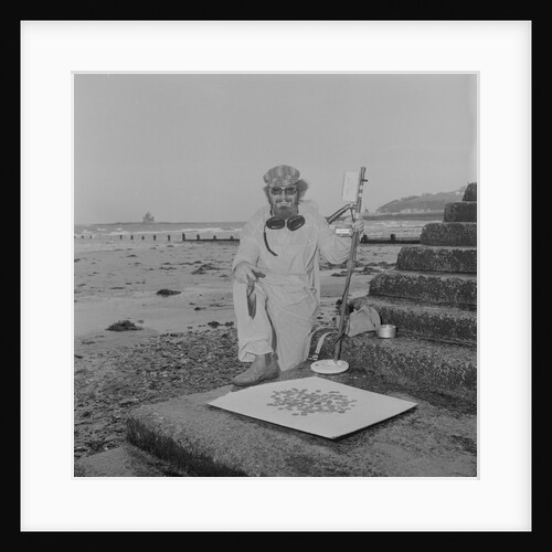Metal detectorist on Douglas beach by Manx Press Pictures