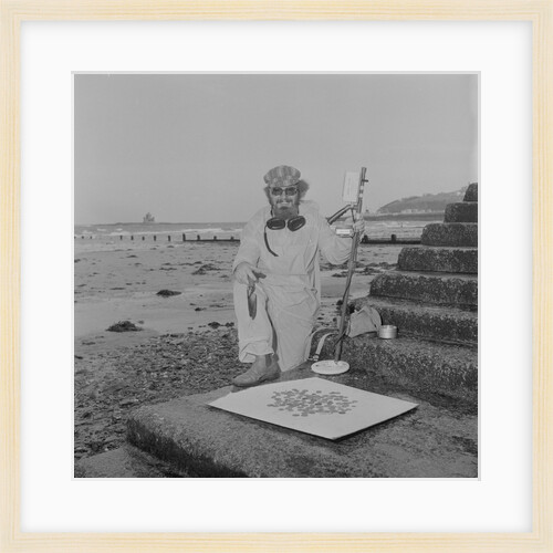 Metal detectorist on Douglas beach by Manx Press Pictures