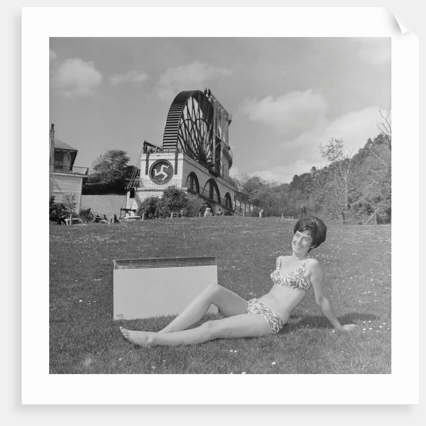 Woman in bikini advertising portable electric heater, Laxey Wheel by Manx Press Pictures