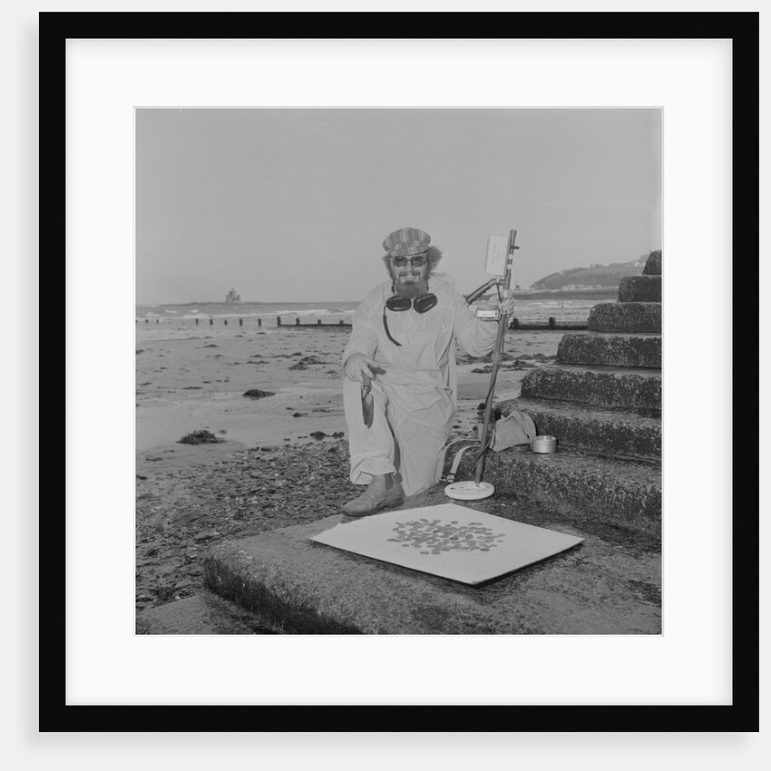 Metal detectorist on Douglas beach by Manx Press Pictures