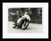 Bob McIntyre, TT (Tourist Trophy) rider, riding 499cc Norton (number 1) over the Mountain by T.M. Badger