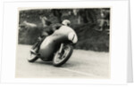 Bob McIntyre, TT (Tourist Trophy) rider, riding 499cc Norton (number 1) over the Mountain by T.M. Badger