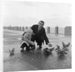 Feeding pigeons on Douglas Promenade by Manx Press Pictures