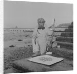 Metal detectorist on Douglas beach by Manx Press Pictures