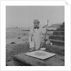 Metal detectorist on Douglas beach by Manx Press Pictures