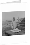 Metal detectorist on Douglas beach by Manx Press Pictures