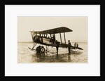 Plane No. 9 on the shore at Ramsey belonging to A.V. Roe and Co. Ltd. G.W. Kewin, town surveyor climbing into the cockpit by Thomas Horsfell Midwood