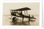 Plane No. 9 on the shore at Ramsey belonging to A.V. Roe and Co. Ltd. G.W. Kewin, town surveyor climbing into the cockpit by Thomas Horsfell Midwood