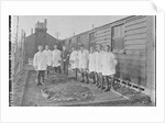 First World War Internee in front of hut with medical/hospital staff, Camp 2, Knockaloe by W H Warburton