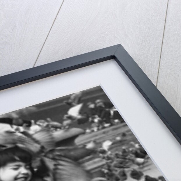 Young girl surrounded by hungry pigeons by Anonymous